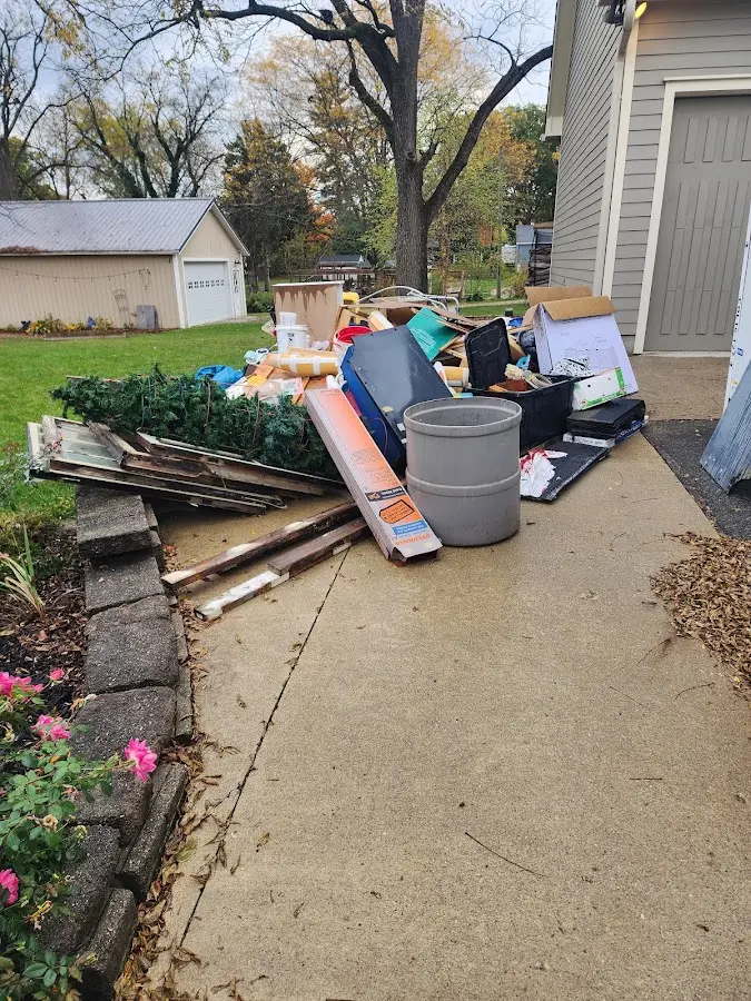Dumpster being loaded with debris for Estate Cleanout Dumpster Rental in Crosby